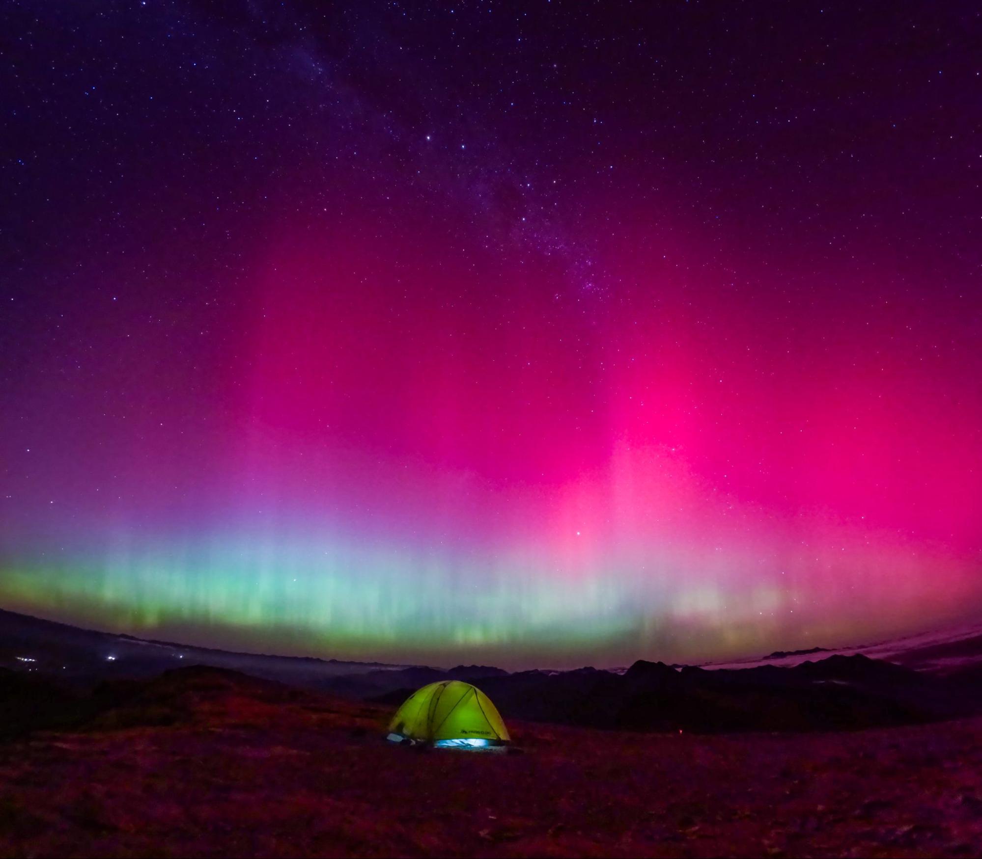 Northern lights over camping tent